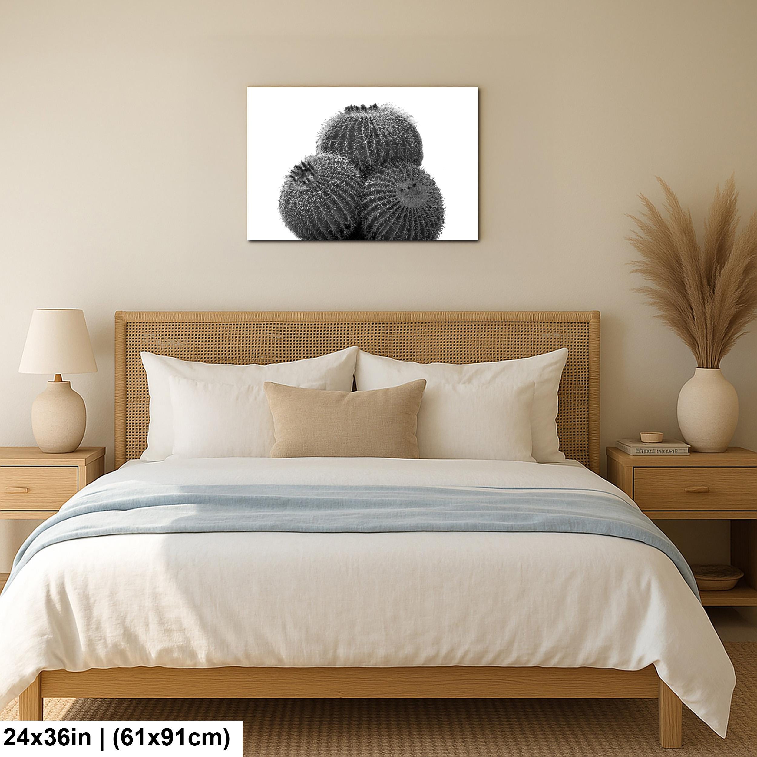 Bedroom with wooden headboard, white bedding, and framed cactus artwork on wall.