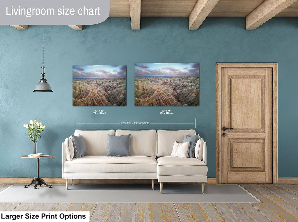 Living room with a sofa, side table, and two wall art prints on a blue wall.