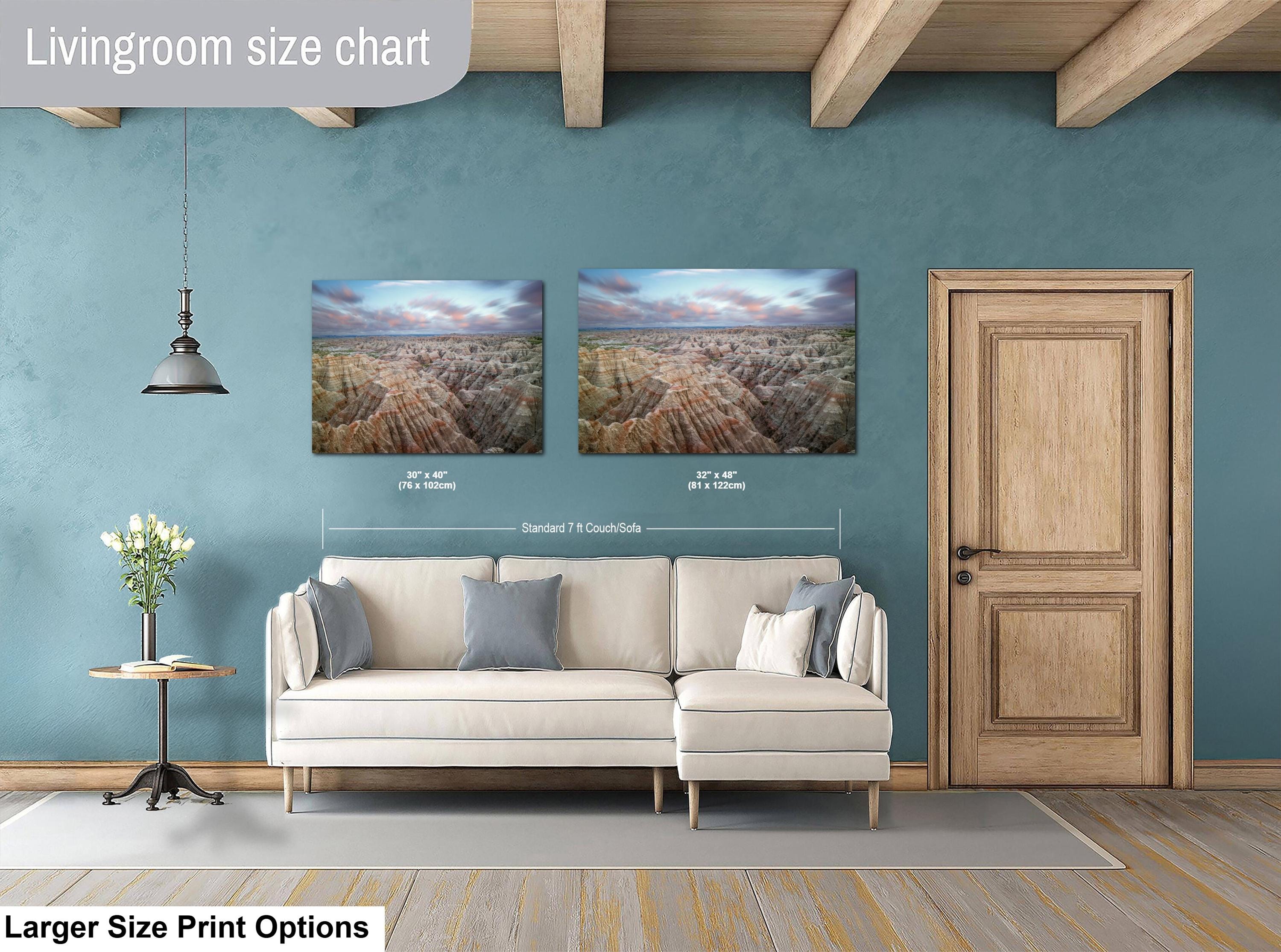 Living room with a sofa, side table, and two wall art prints on a blue wall.