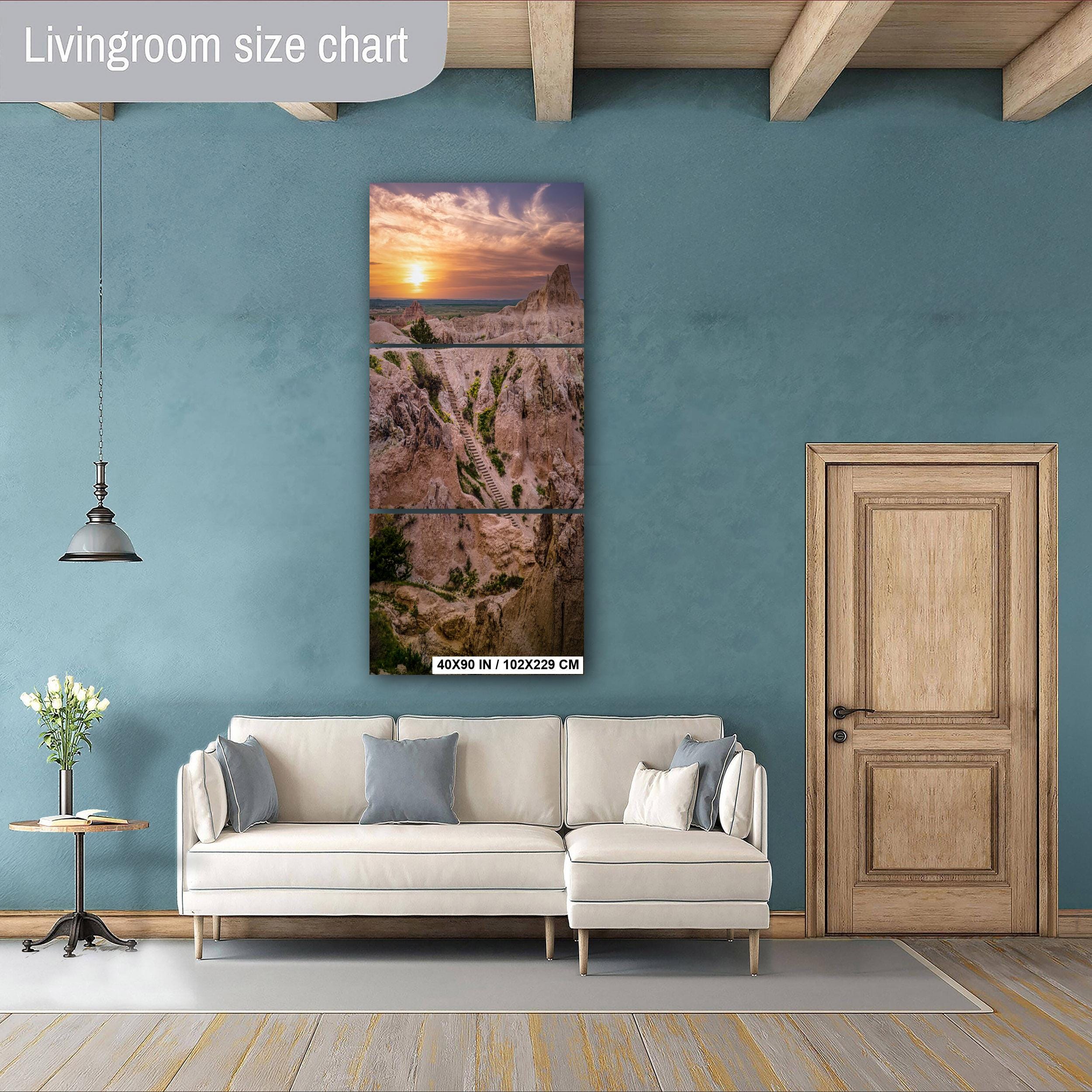 Living room with a large wall art piece depicting a sunset over a landscape.