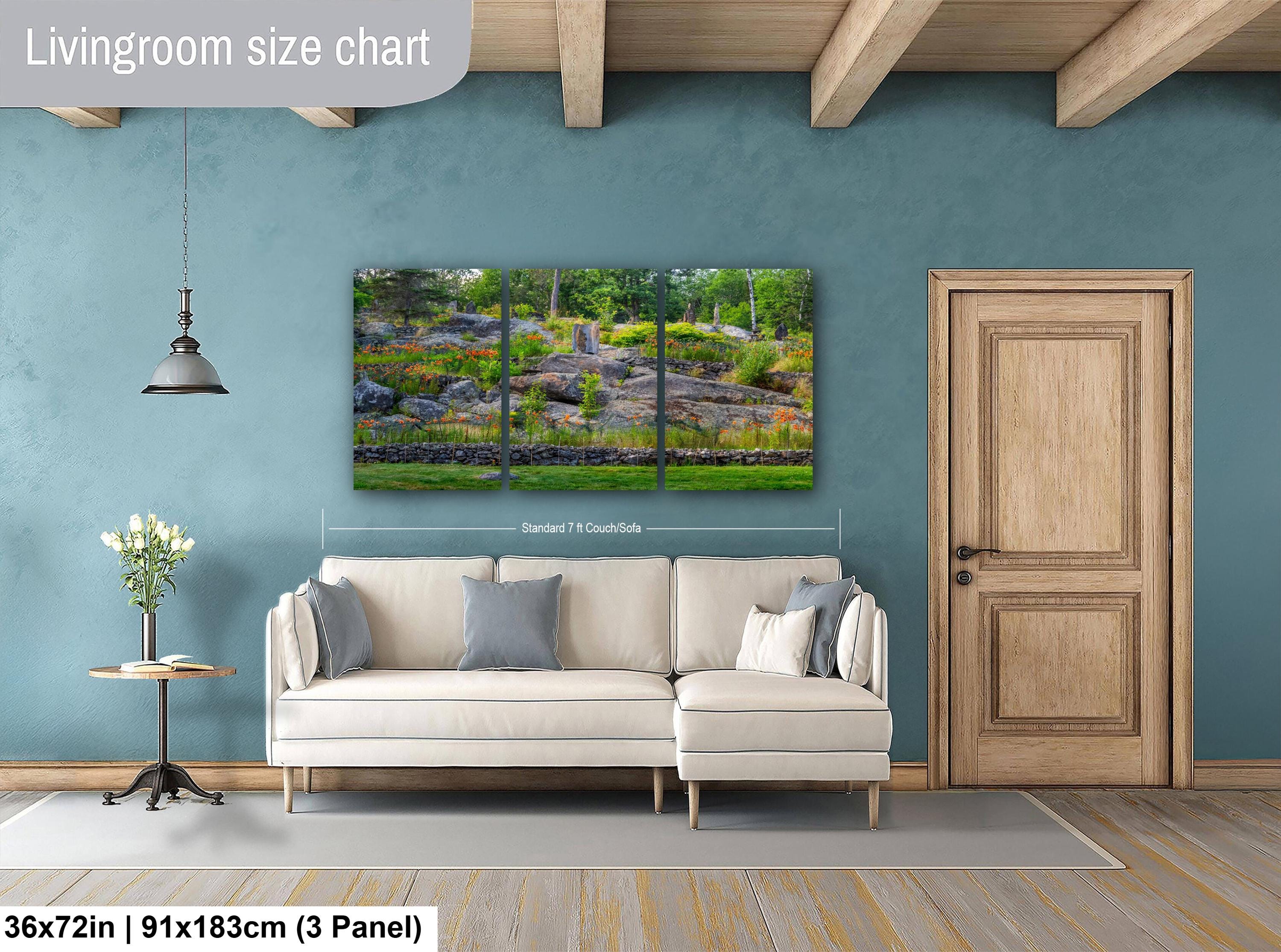 Living room with a sofa, side table, and wall art on a blue wall.