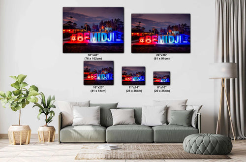 Wall art with '#BEMIDJI' text in various sizes displayed above a sofa.