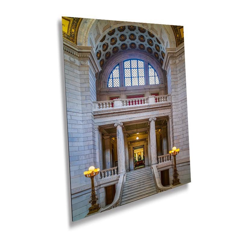 A wall art print featuring the Rhode Island State House, depicting a grand staircase and an arched doorway with intricate details and a brightly lit interior.