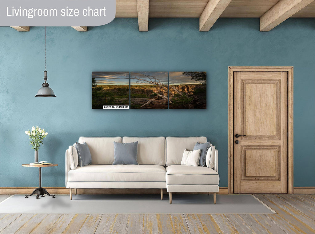 Living room with a beige sectional sofa, side table, and wall art on a blue wall.