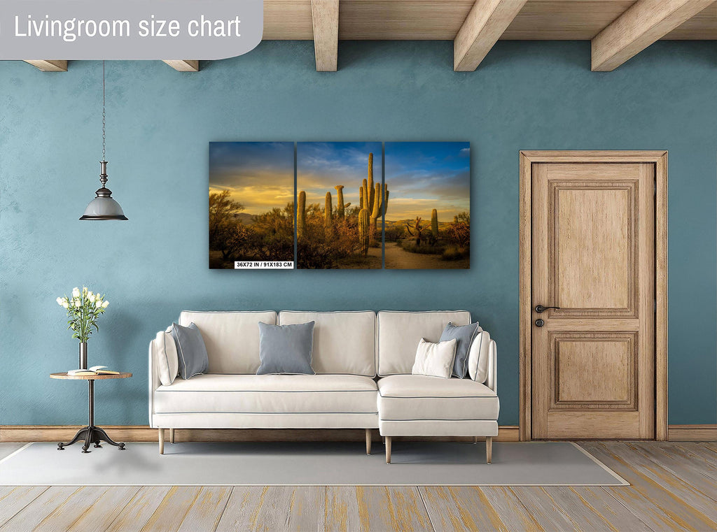 Living room with a large wall art piece of desert landscape, beige sofa, and wooden door.