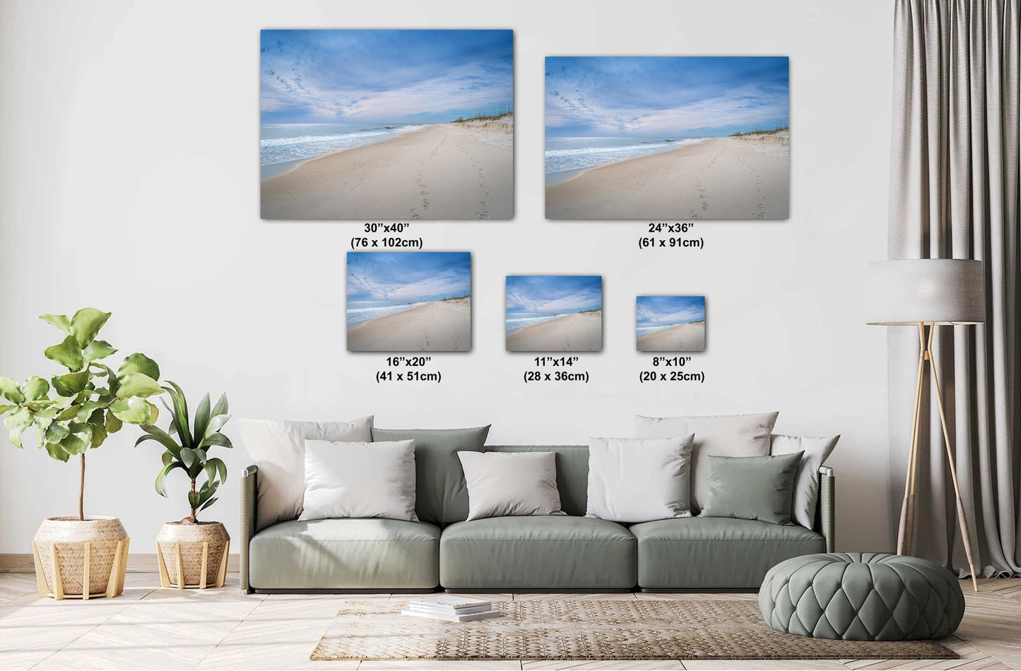 A living room with a green sofa featuring various sizes of beach photography canvas prints on the wall, ranging from 8"x10" to 30"x40".