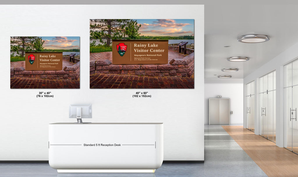 Two wall art showing scenic views of Rainy Lake Visitor Center in a modern office setting.