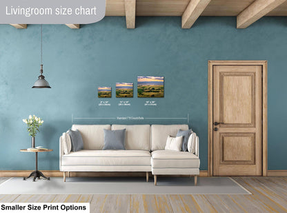 Living room with a sofa, side table, and wall art prints on a blue wall.
