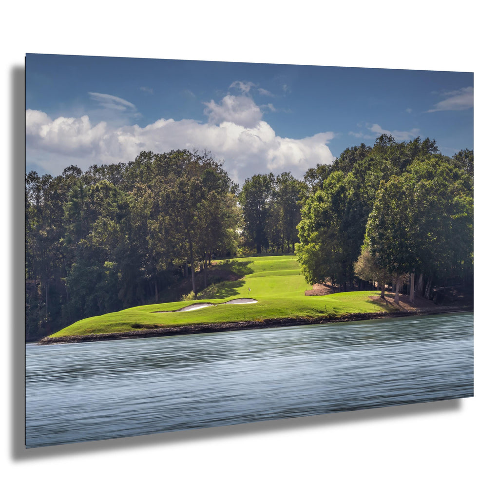 Scenic golf course on Lake Keowee surrounded by lush trees and calm waters