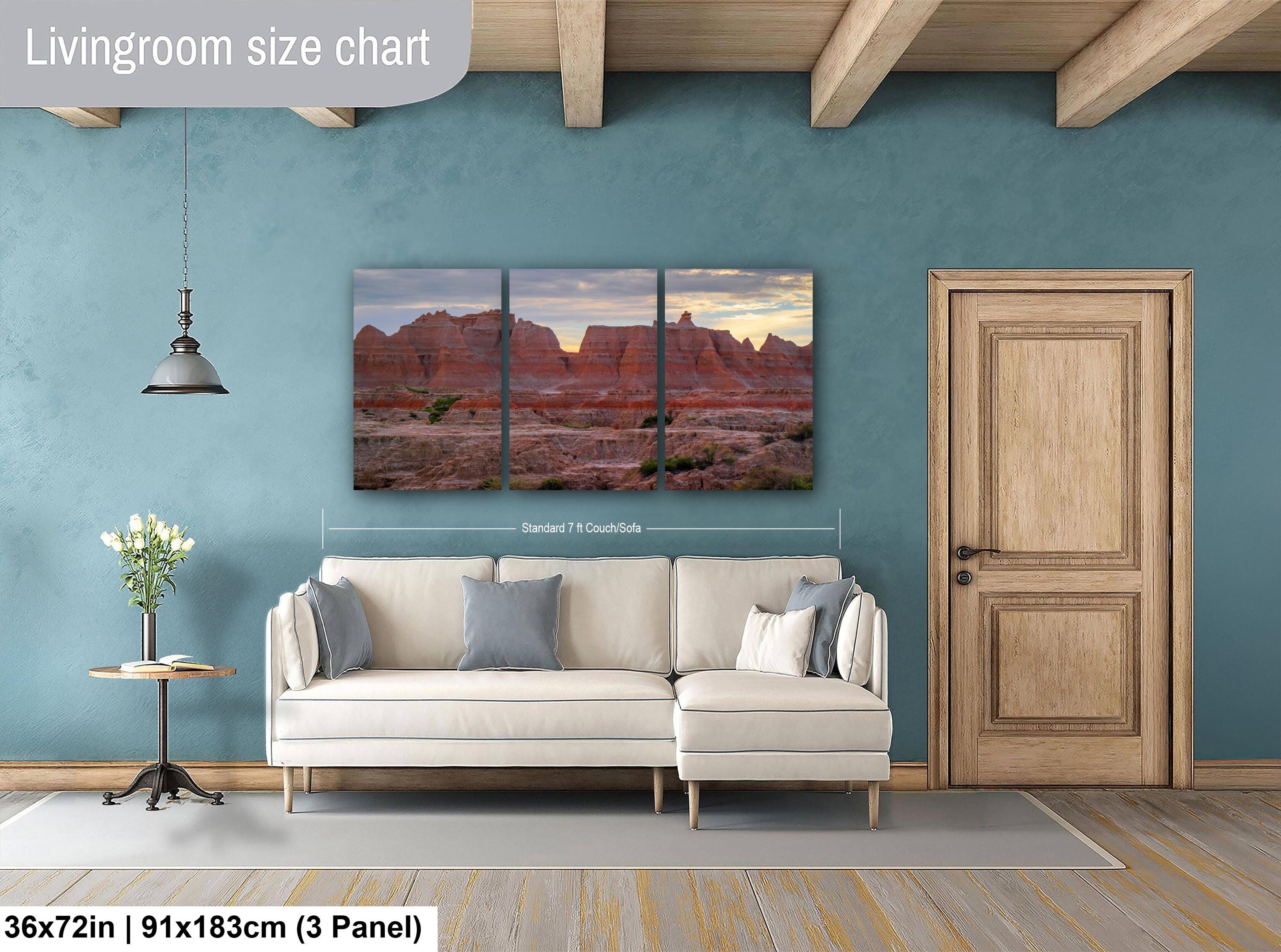 Living room with a beige sofa, side table, and wall art depicting a desert landscape.