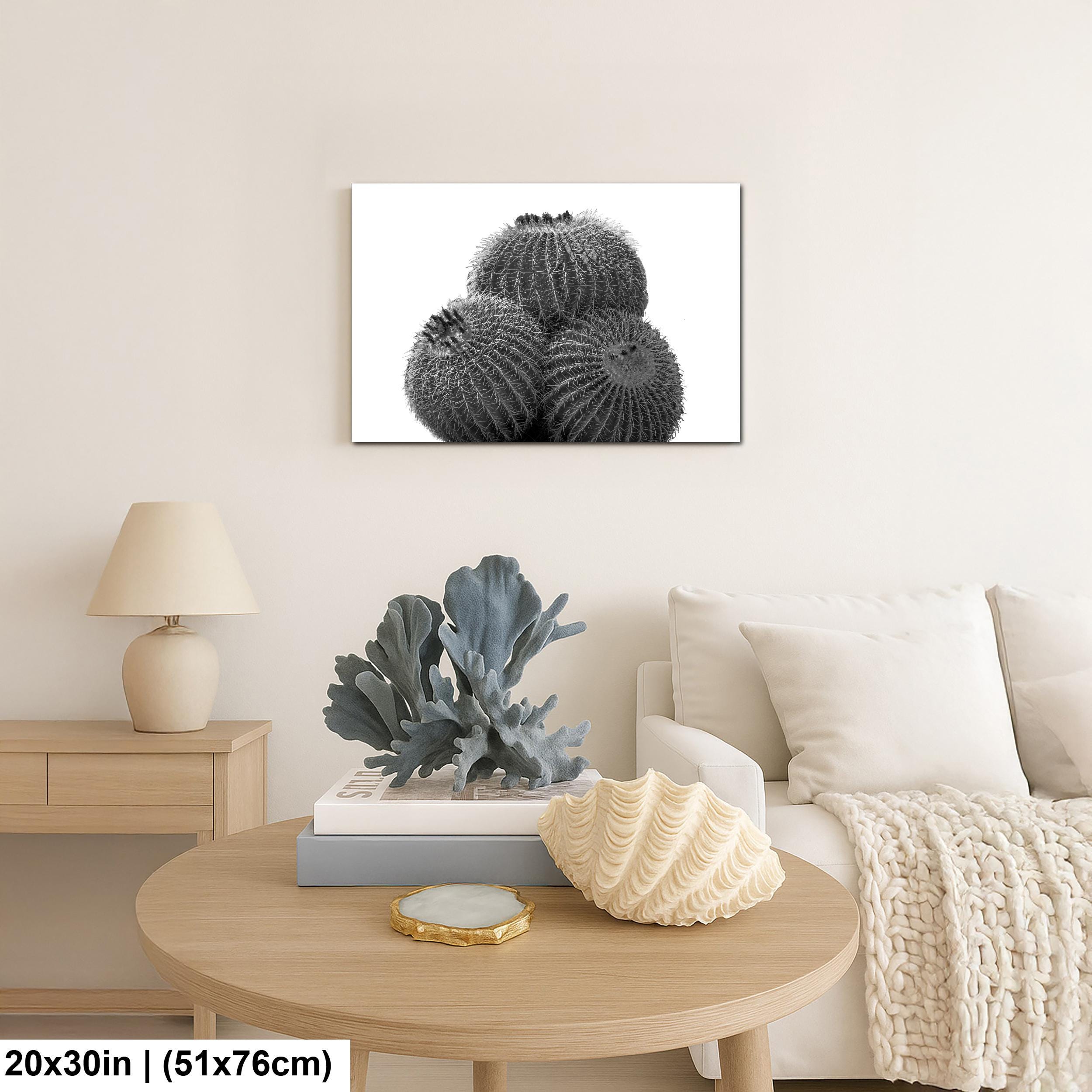 Living room with a painting of cacti on the wall, a lamp, and decorative items on a table.