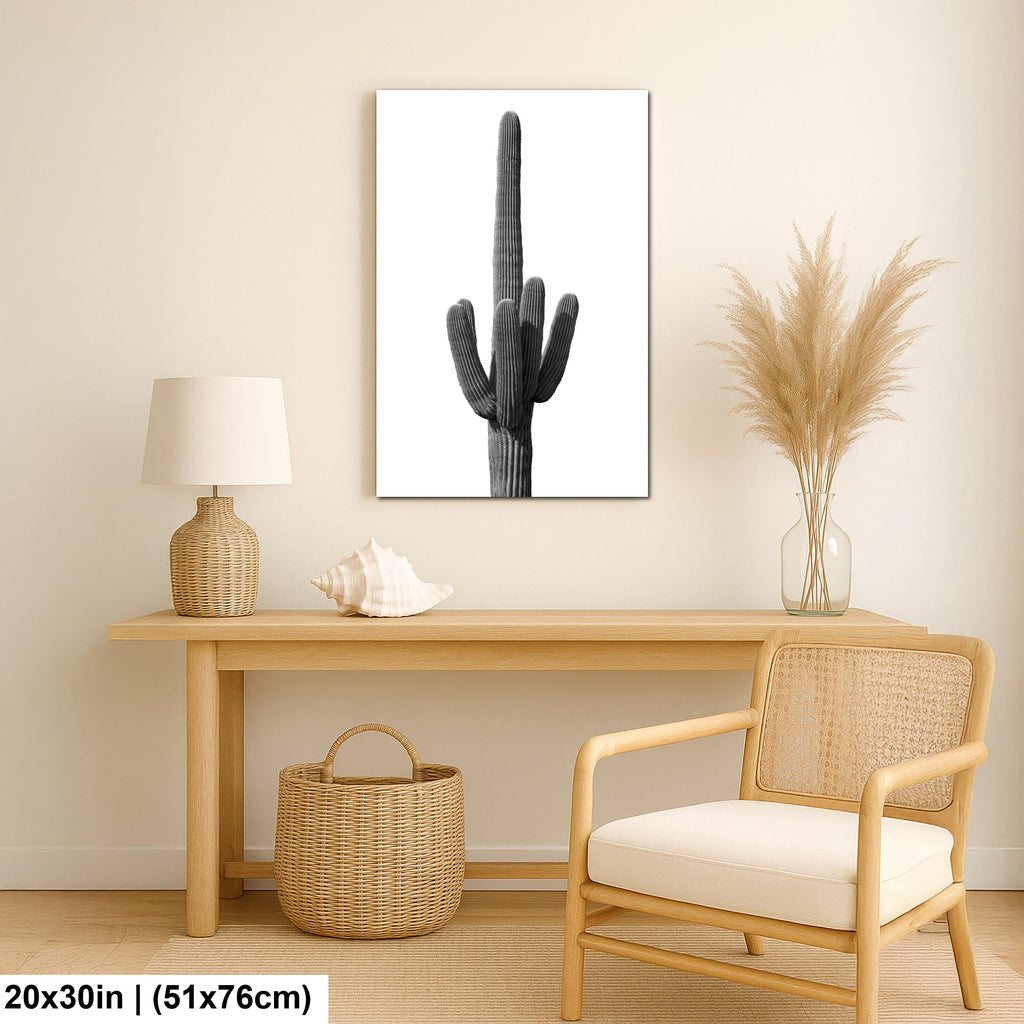 Nautical-themed room with a wooden desk, lamp, shell, basket, and cactus wall art print.