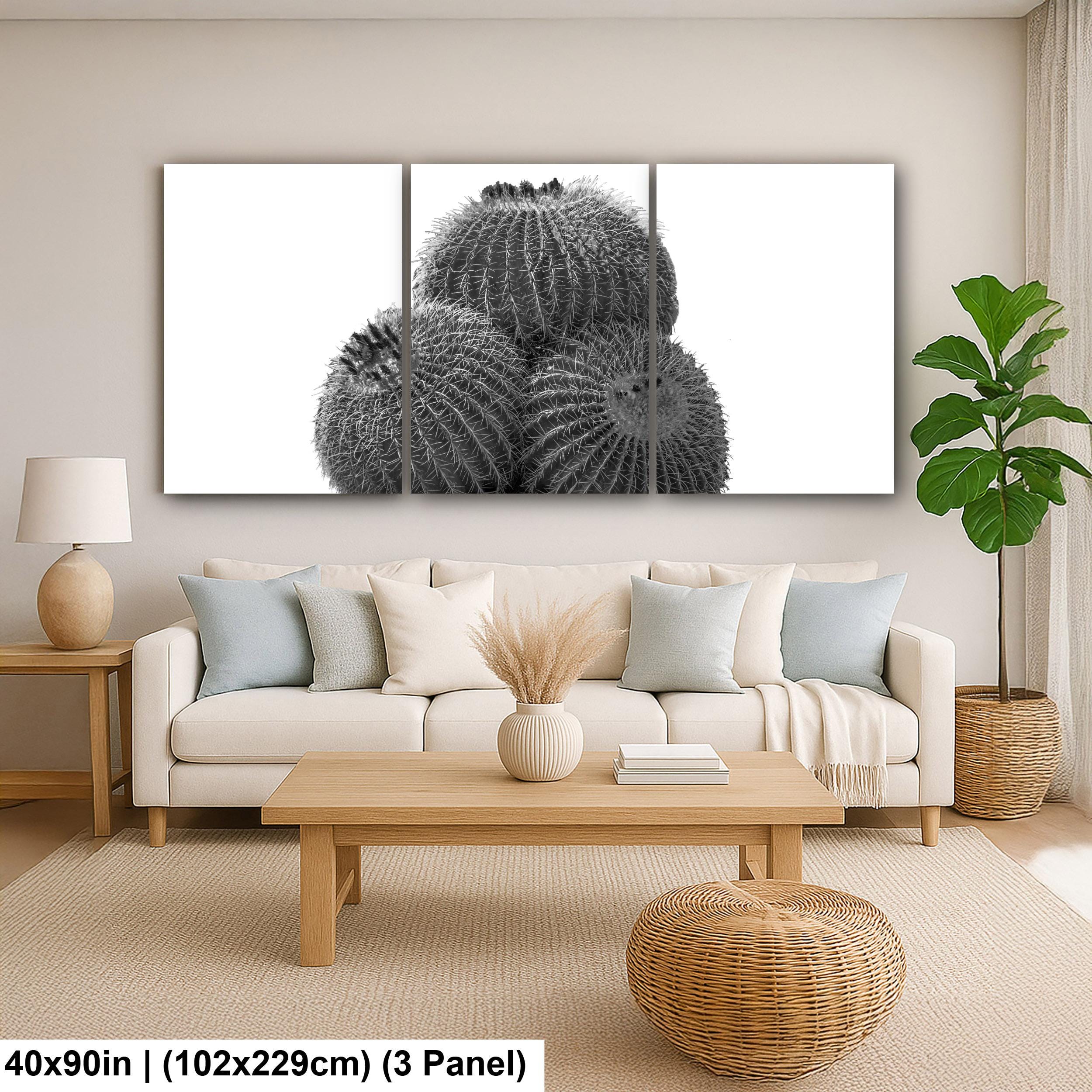 Living room with a large wall art piece of cacti, beige sofa, wooden coffee table, and decorative items.
