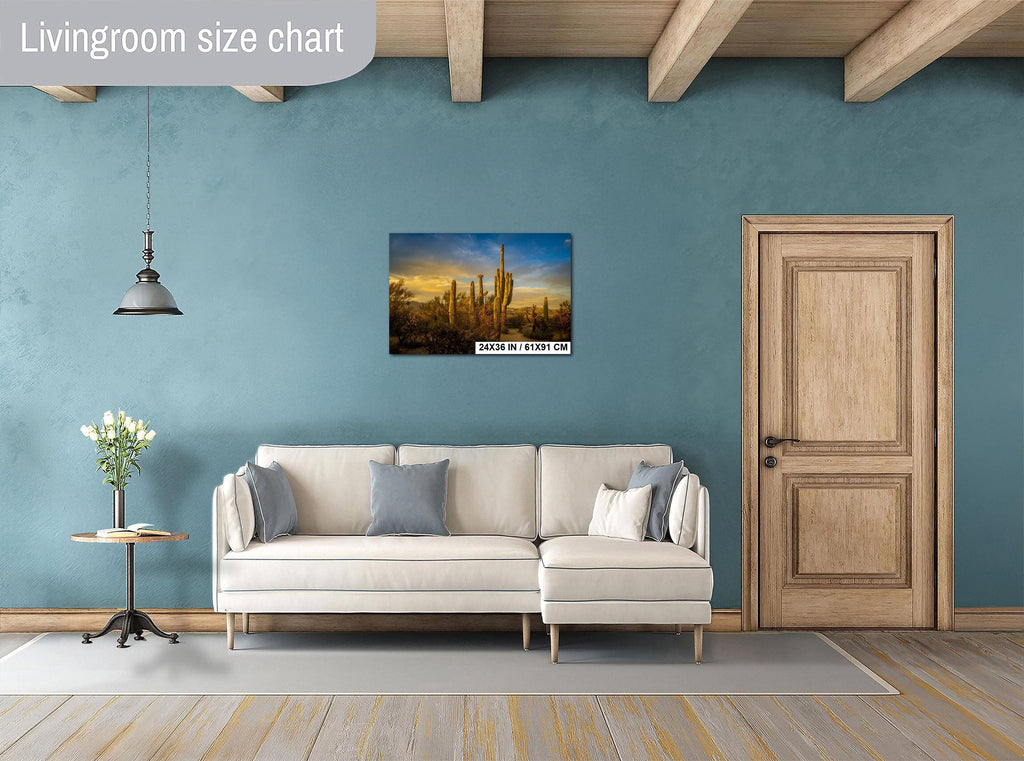 Living room with a beige sofa, decorative pillows, a small table with a plant, and a painting on the wall.