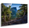 Bear Lake in Rocky Mountain National Park with calm waters reflecting mountains and evergreen trees.