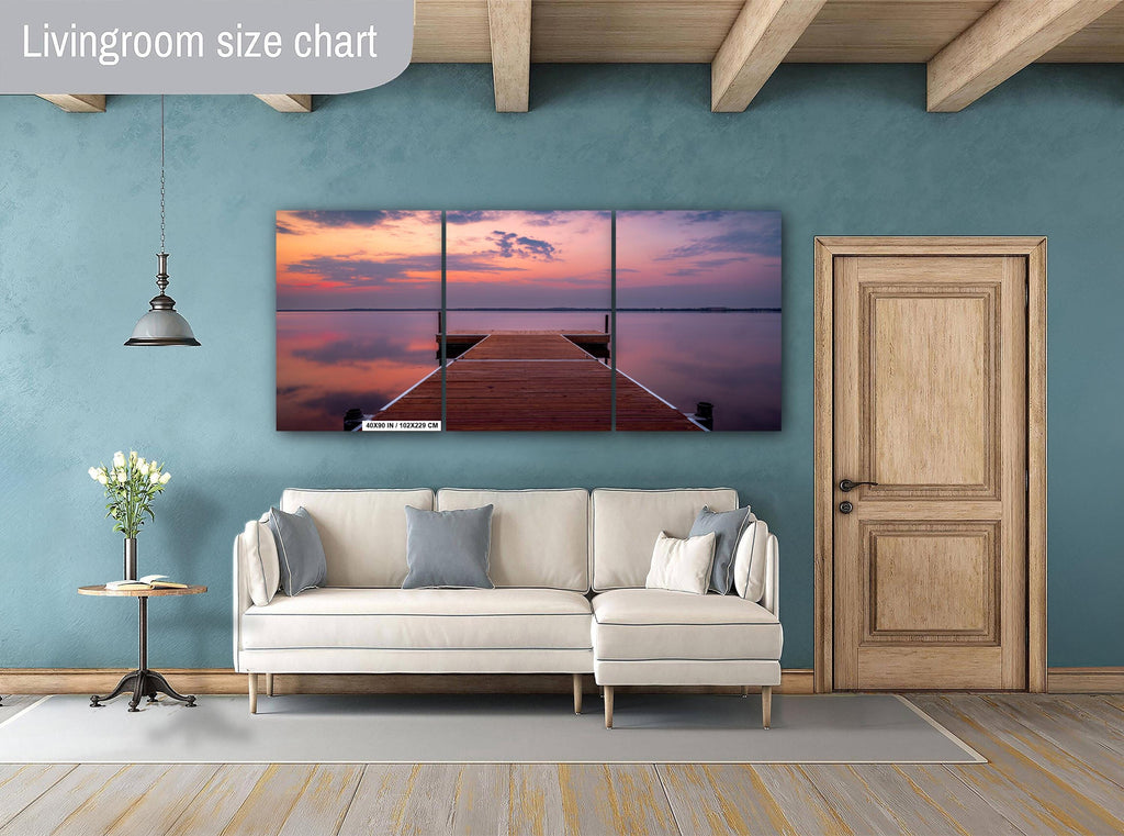 Sunset over calm Lake Bemidji with dock view and pastel skies before a summer storm 3-panel wall art hanging in living room.