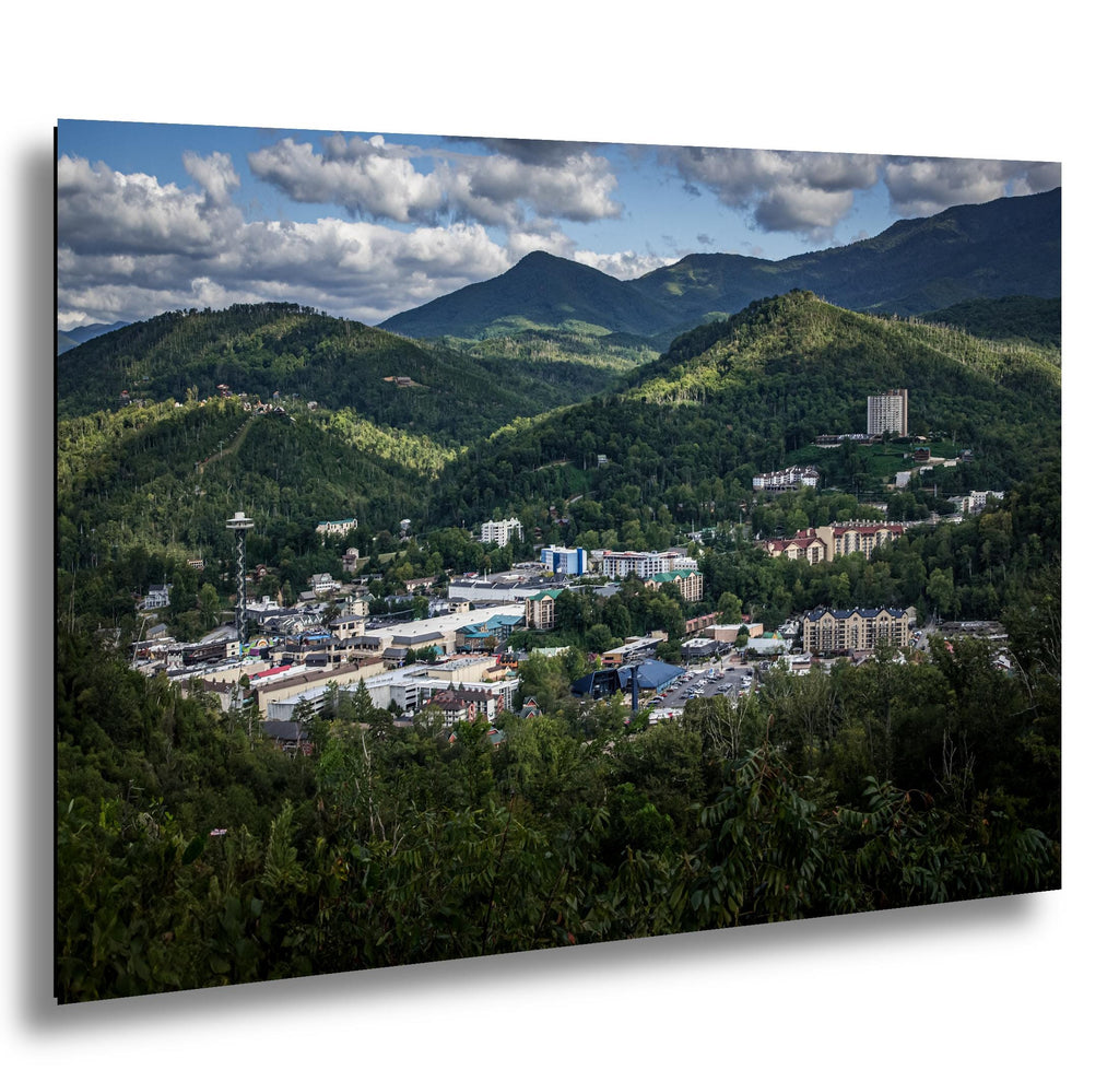 Gatlinburg nestled in Smoky Mountain hills under soft clouds, from an overlook