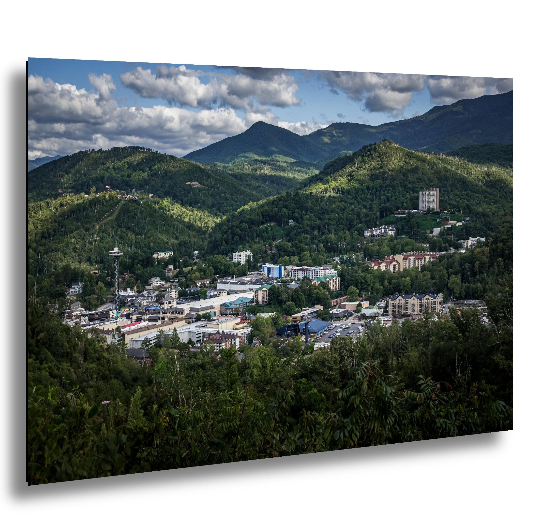 Gatlinburg nestled in Smoky Mountain hills under soft clouds, from an overlook