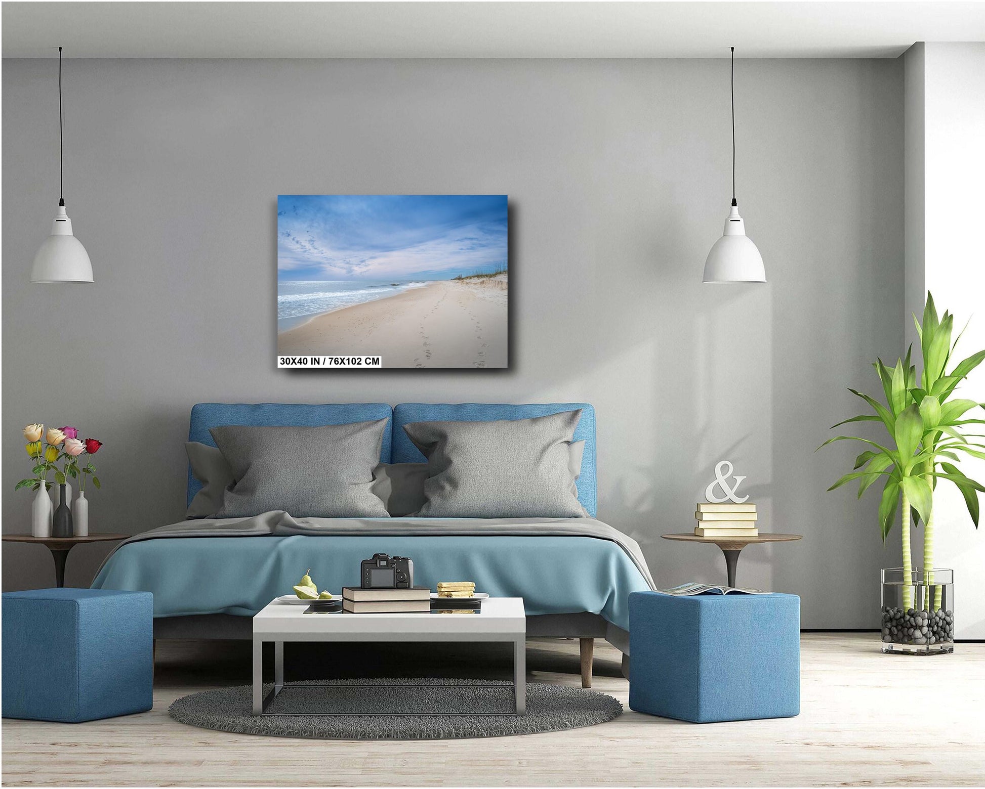 A wall art print featuring a beach scene with footprints on the sand, the ocean, and a clear sky.