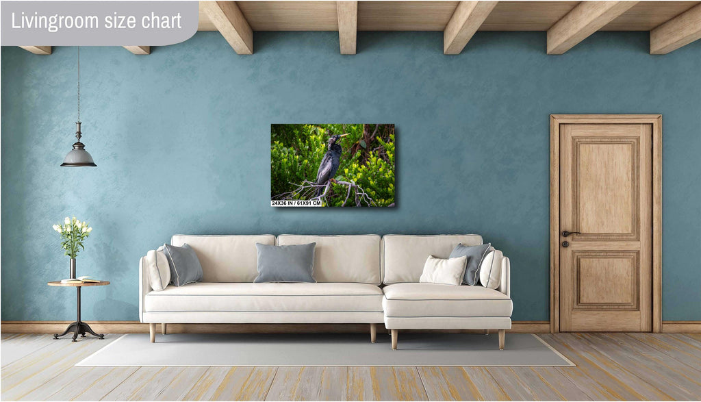 A print wall art depicting a black Anhinga bird perched on branches in a wetland setting, with vibrant green foliage in the background.