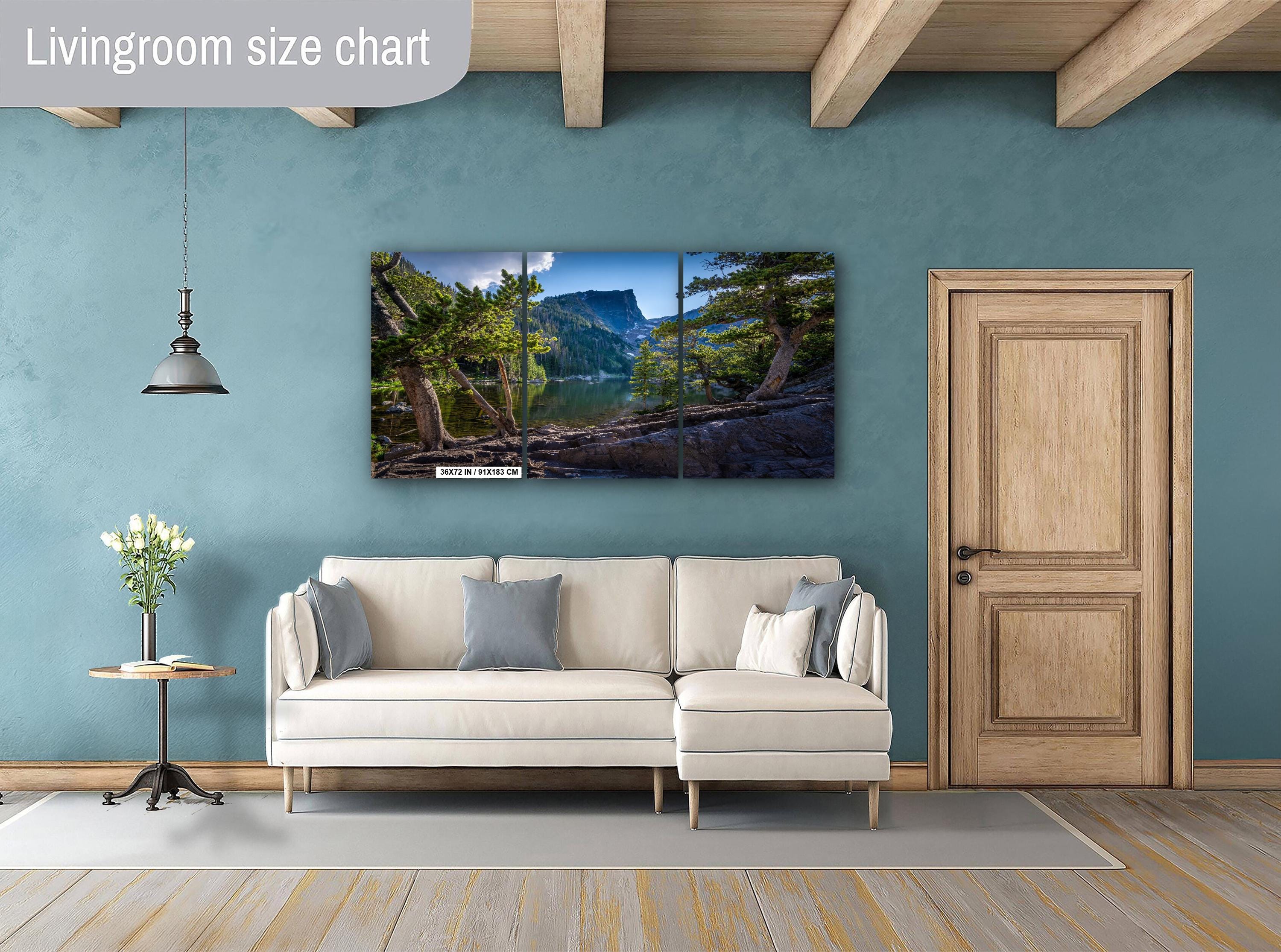 Living room with a TV displaying a nature scene, beige sofa, and wooden door.