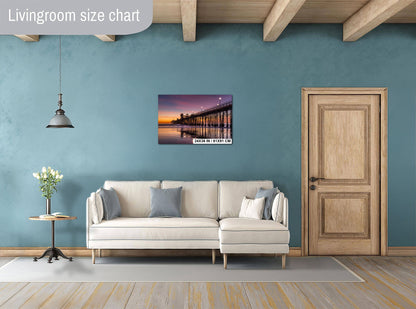 a living room with a white sofa, a wooden door, and a painting of a bridge in the background.