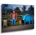Paul Bunyan and Babe the Blue Ox statues in Bemidji, Minnesota at dusk.
