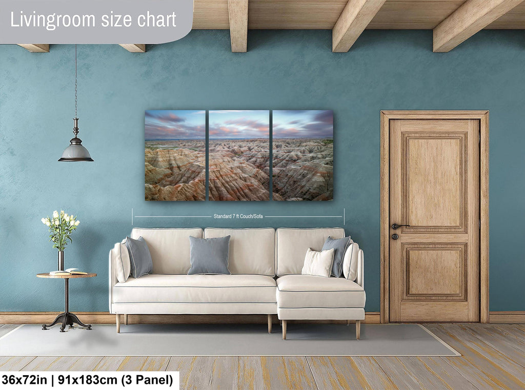 Living room with a sofa, side table, and wall art on a blue wall.
