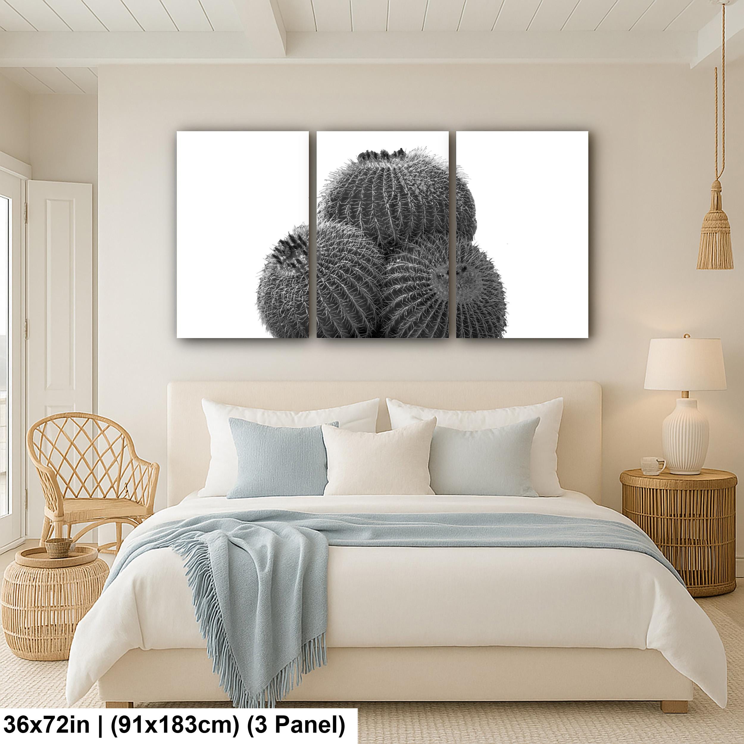 Bedroom with a large wall art piece of cacti above the bed.