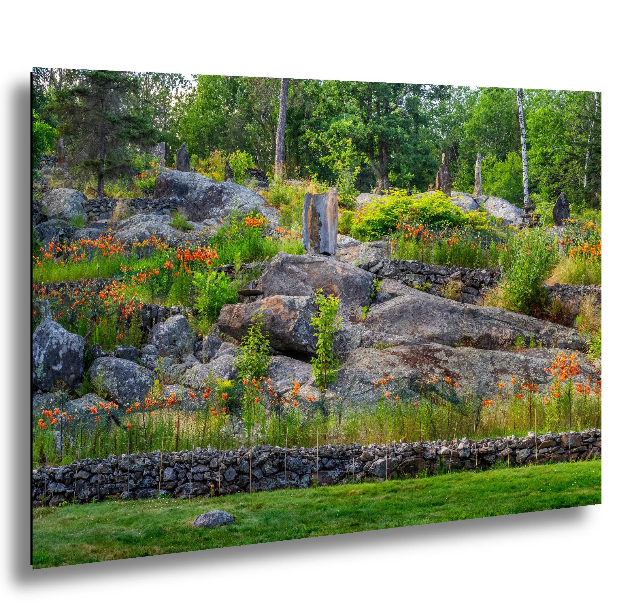 Ellsworth Rock Gardens with stone sculptures and blooming wildflowers.