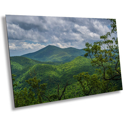 A wall art print featuring a scenic view of the Blue Ridge mountains with lush greenery and clouds in the background.