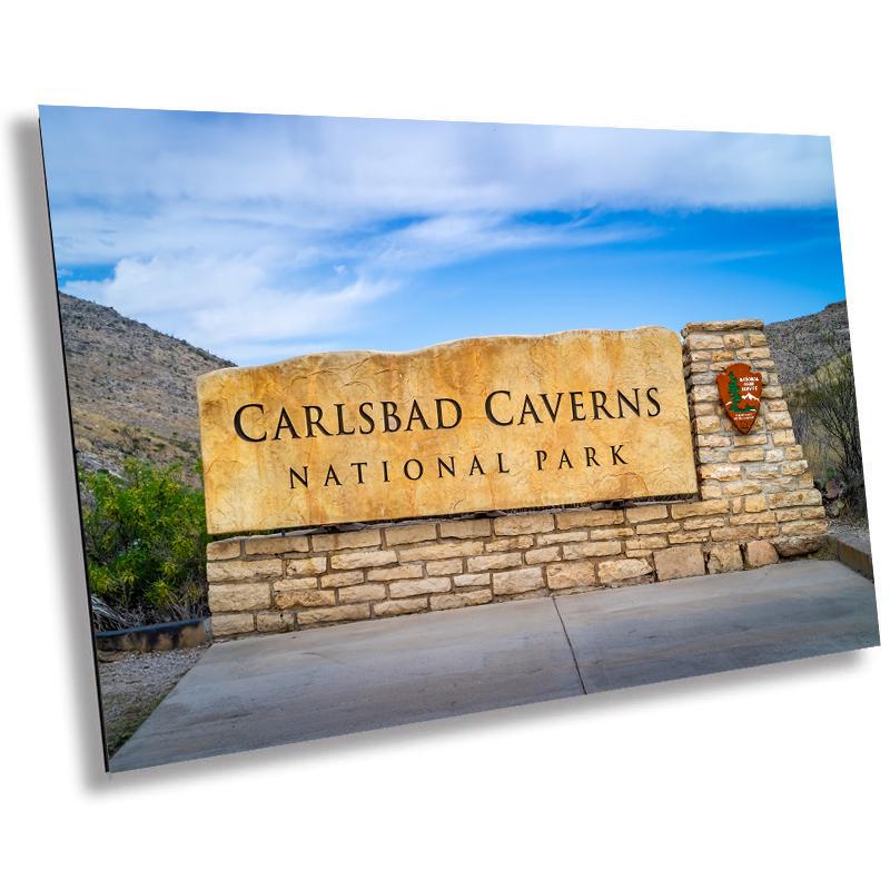 A wall art print featuring the Carlsbad Caverns National Park entrance sign with a scenic background.