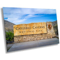 A wall art print featuring the Carlsbad Caverns National Park entrance sign with a scenic background.