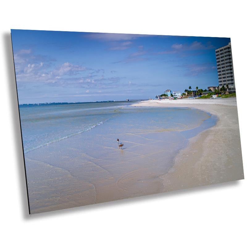 A canvas print featuring a seascape view of DiamondHead Beach Resort in Fort Myers, Florida, with a clear blue sky and calm waves in the foreground.