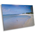 A canvas print featuring a seascape view of DiamondHead Beach Resort in Fort Myers, Florida, with a clear blue sky and calm waves in the foreground.